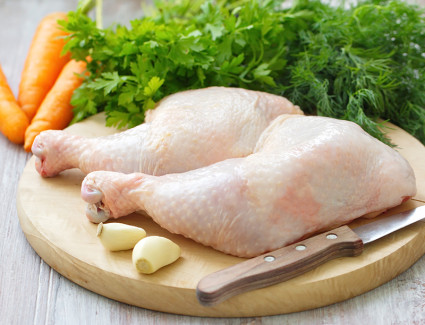 Raw chicken legs with vegetables and spices ready for cooking