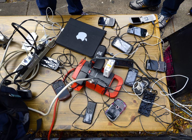 People  wait to have phones and laptops charged off a generation set up in the West Village November 1, 2012 as New Yorkers cope with the aftermath  of Hurricane Sandy.  The storm left large parts of  York City without power and transportation. The   AFP PHOTO / TIMOTHY A. CLARY        (Photo credit should read TIMOTHY A. CLARY/AFP/Getty Images)